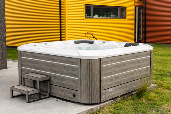 1400L rafmagnspottur út í garði með gult hús í bakgrunn