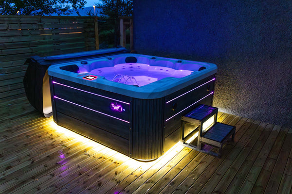 Rafmagnspottur á palli 1000L 4 manna að kvöldi til með fjólubláa led lýsingu